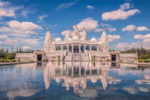 BAPS Shri Swaminarayan Temple as seen across a reflection pool. This traditional Hindu temple is one of the best places to take pictures in Houston TX