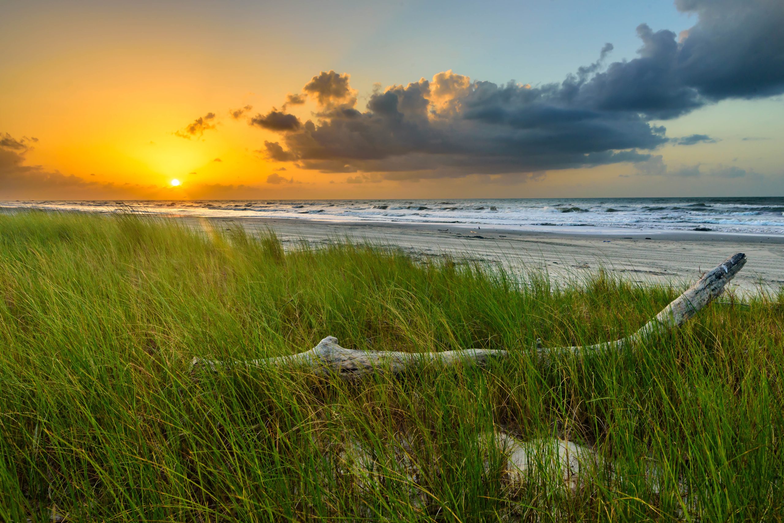sunset over the beach in one of the best beach towns in texas