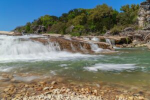small waterfall in pedernales falls state park, one of the best state parks in texas
