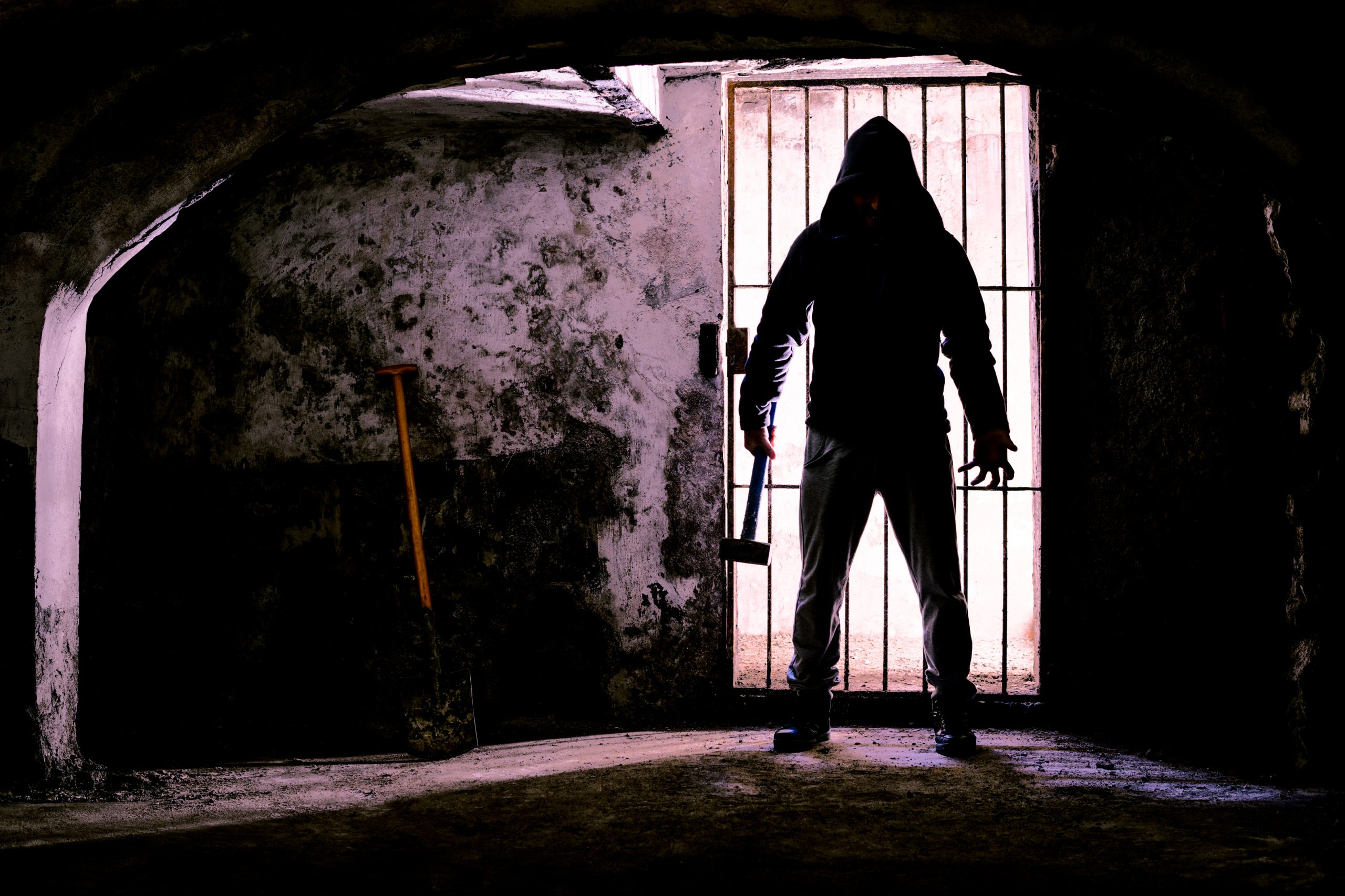 scary dark man holding a weapon in a dungeon, forth worth haunted houses