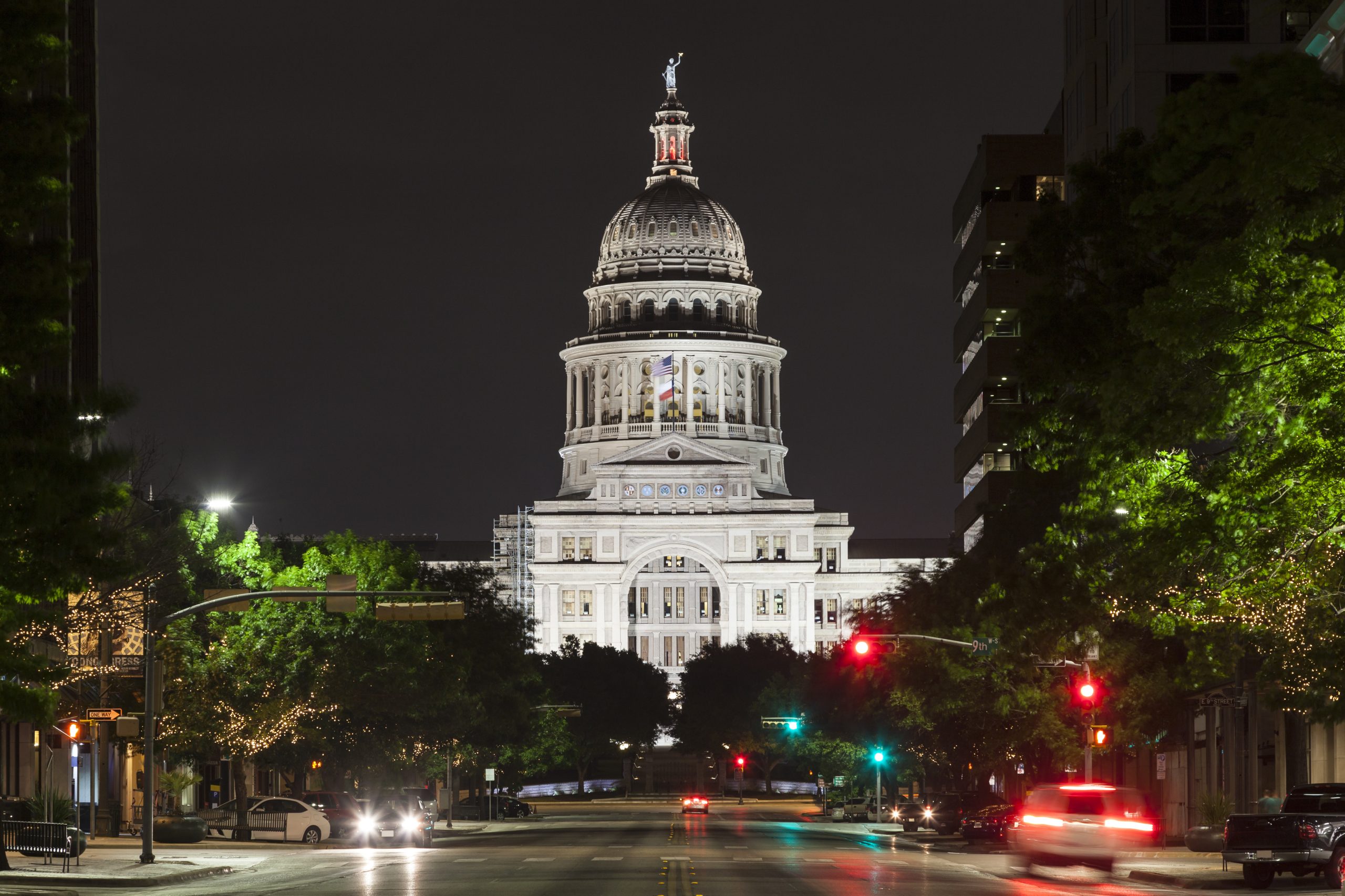 view of texas state capitol building from congress street at night, one of the most haunted places in austin tx