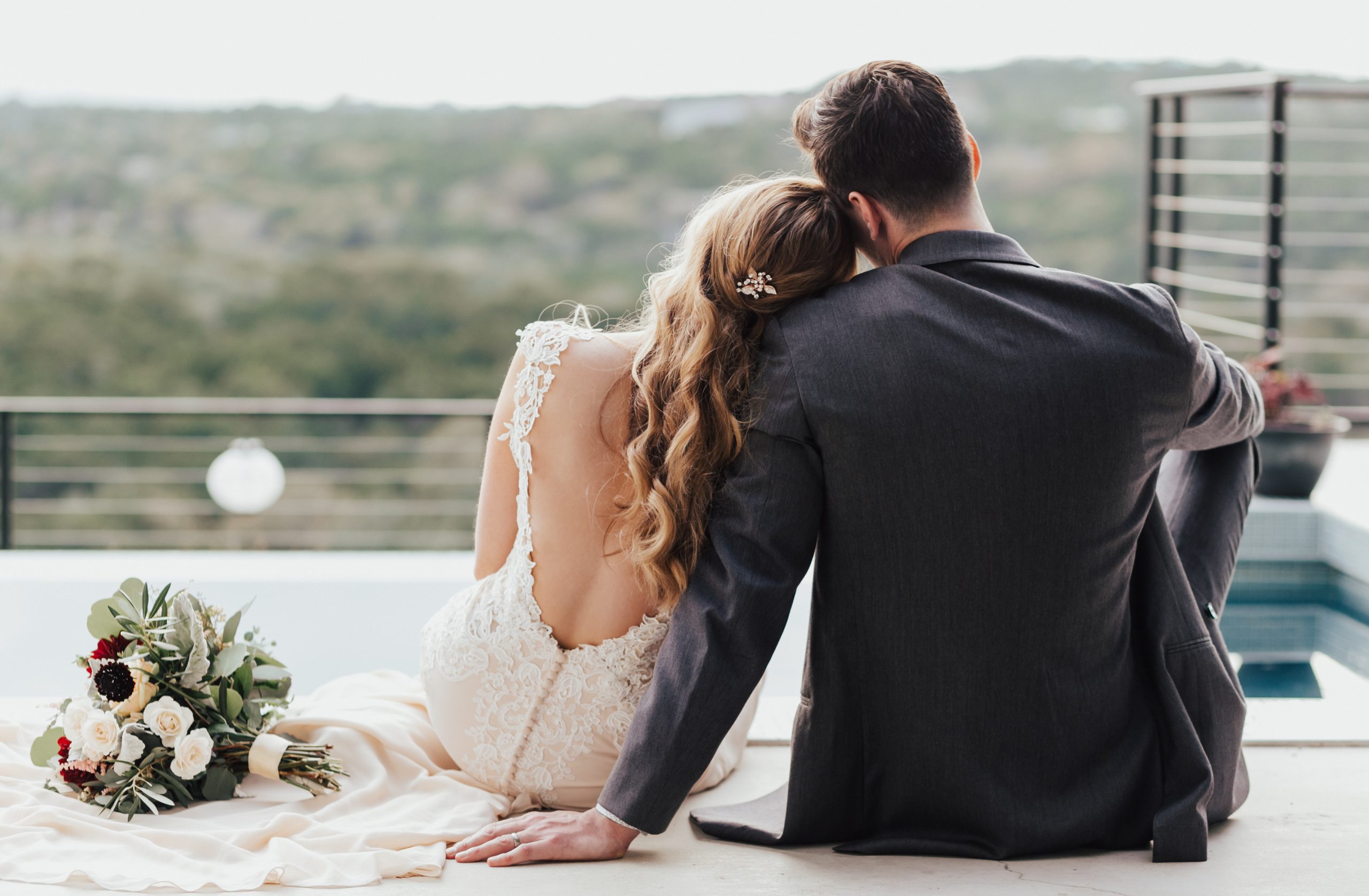 couple wearing wedding outfits overlooking the hill country at the beginning of a texas honeymoon destinations