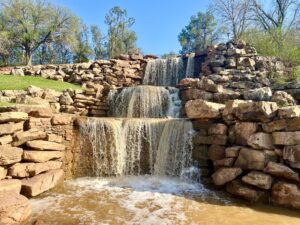 photo of wichita falls waterfalls in wichita falls texas, as seen from trail in front of them on a sunny day